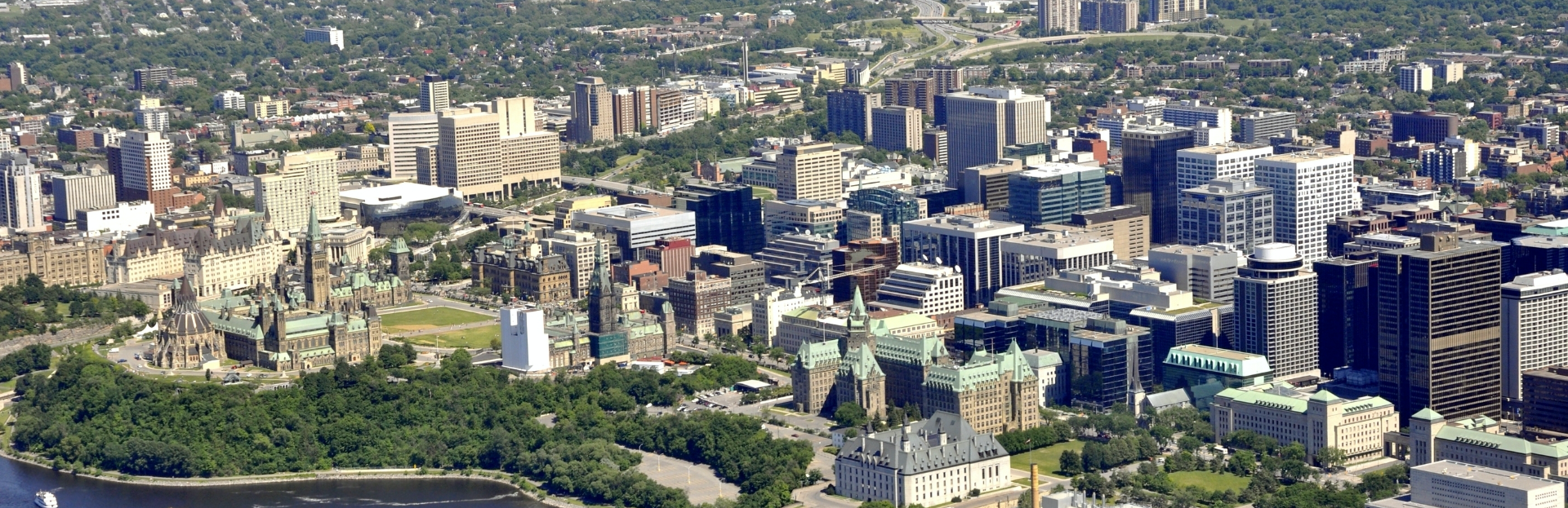 Bird's eye view of city with buildings and parks visible.