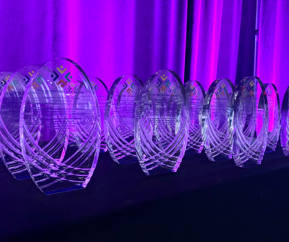 Glass awards on a table in purple lighting